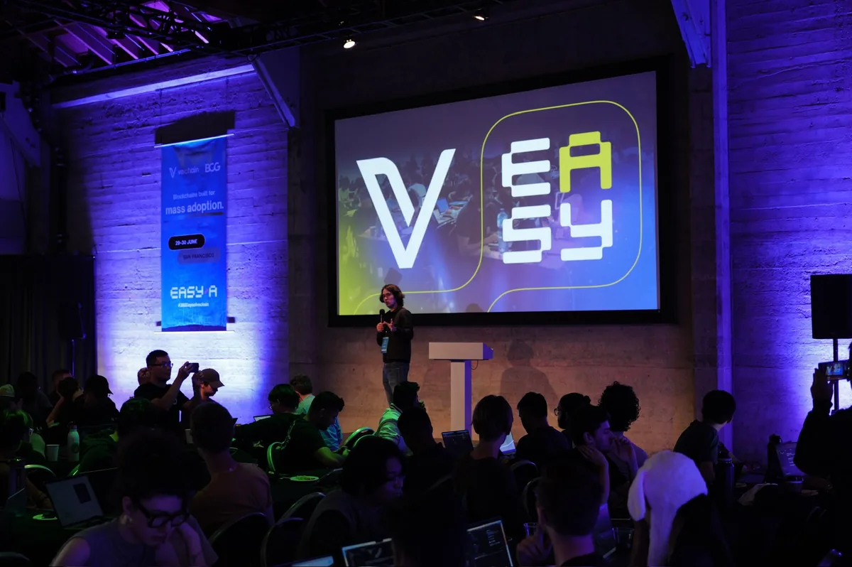 A talk under the EasyA and VeChain screen at the EasyA x VeChain hackathon in San Francisco